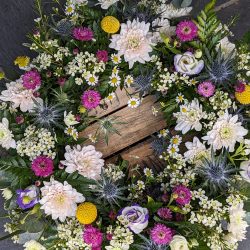 Mixed-flower wreath for funeral by Just So Flowers