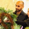 A man making a Christmas wreath tutored by Just So Flowers