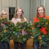 Three ladies with the Christmas wreaths they have made at a wreath workshop