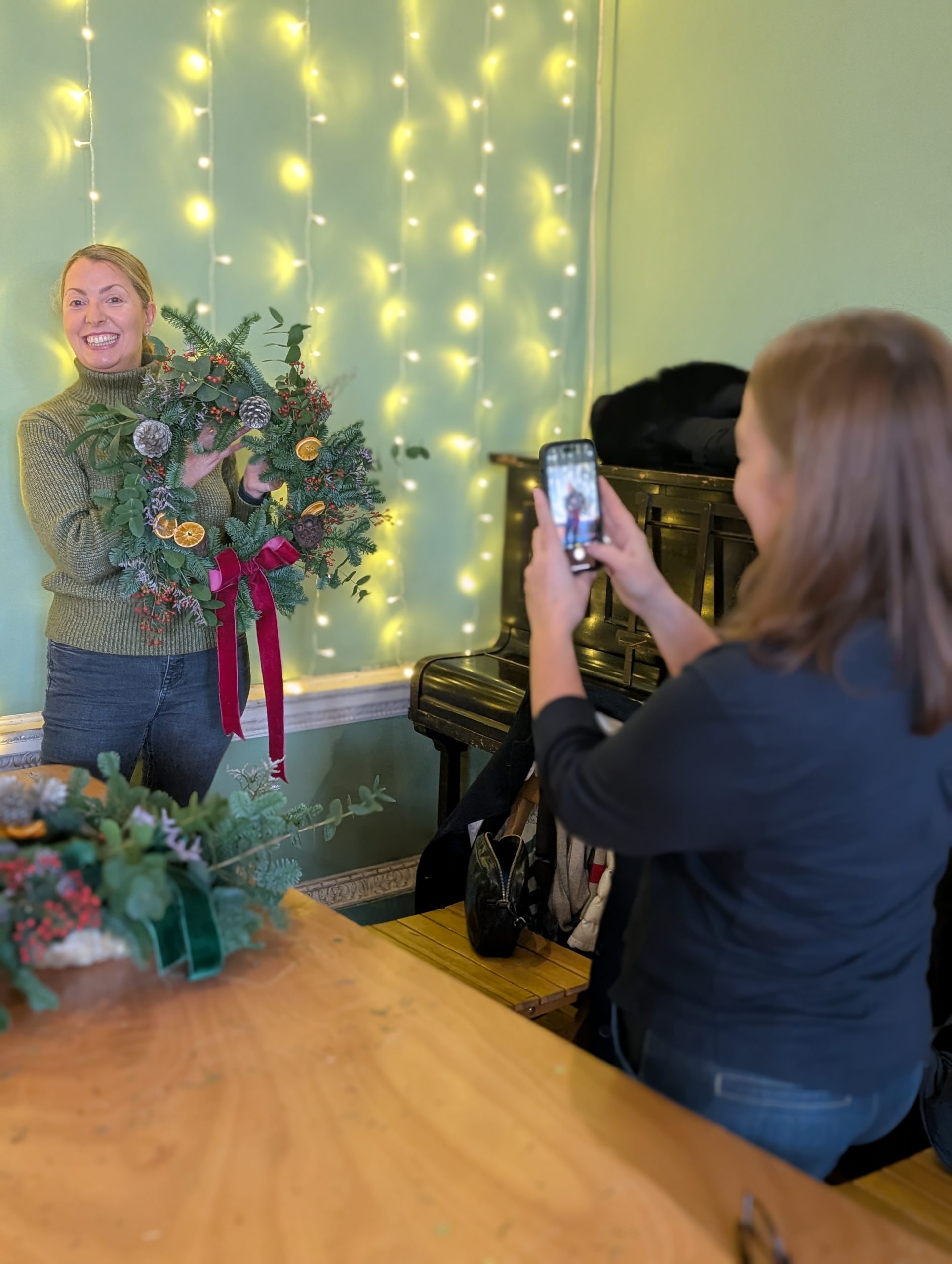 Christmas wreath makers taking a photo of the wreaths they made