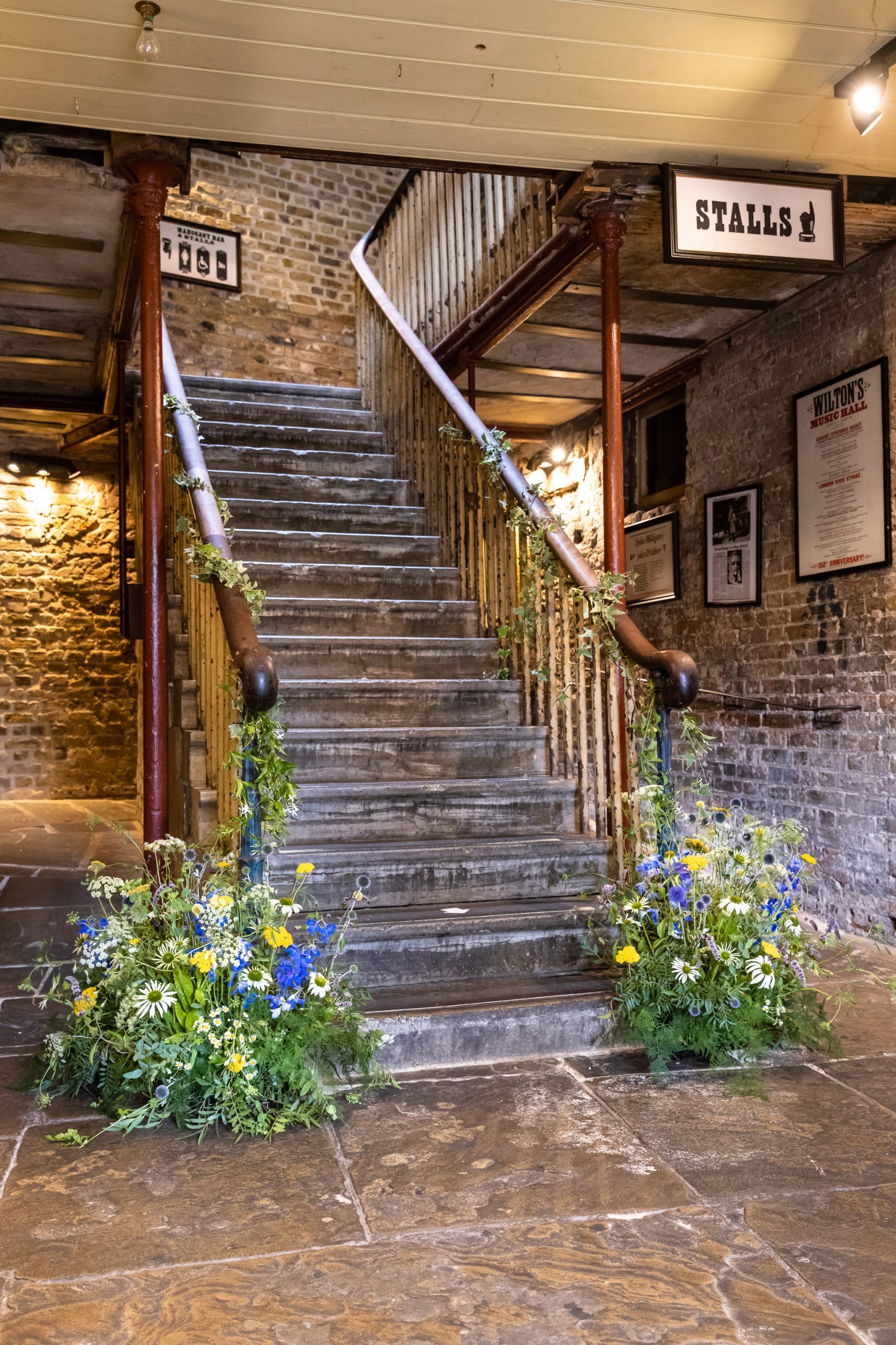 The stairway at Wilton's Music Hall with Flowers by Just So Flowers