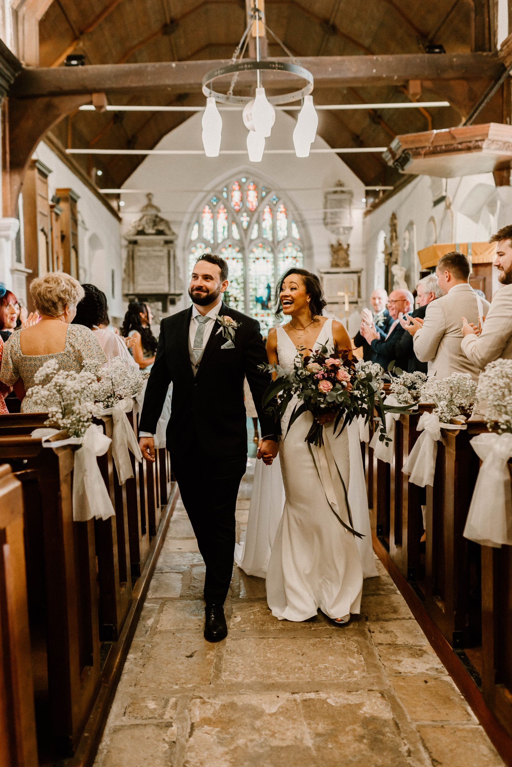 Bride and Groom in church with Flowers by Just So Flowers